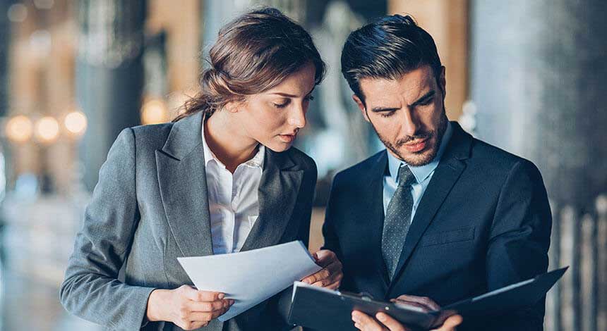 Female and Male Attorneys Comparing Notes